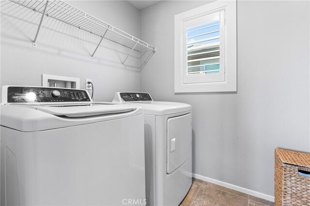 laundry area with washer and dryer, laundry area, and baseboards