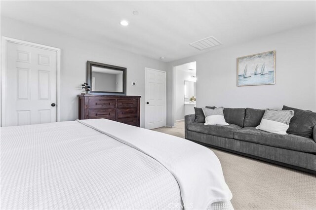 bedroom featuring recessed lighting, visible vents, and light carpet