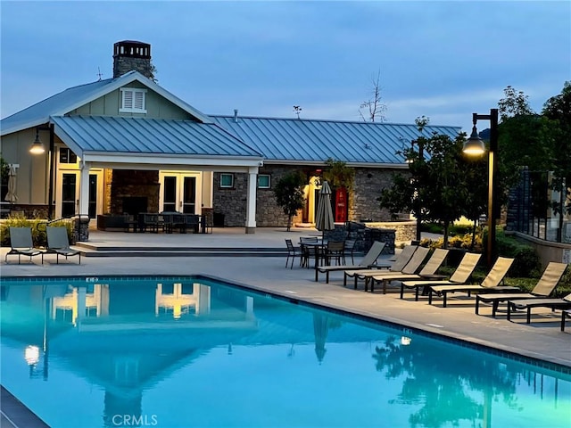 pool featuring an exterior structure, french doors, a patio, and an outdoor structure