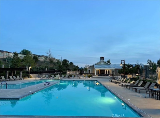 pool featuring a patio and fence