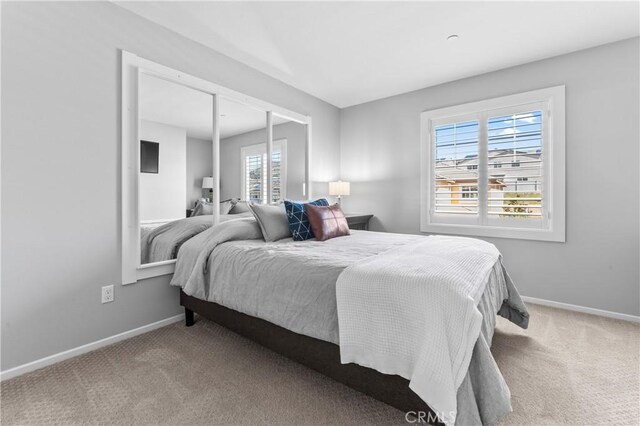 carpeted bedroom with baseboards