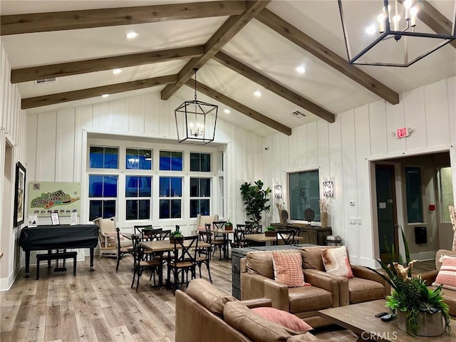 living room with light wood-style floors, beam ceiling, a notable chandelier, and visible vents