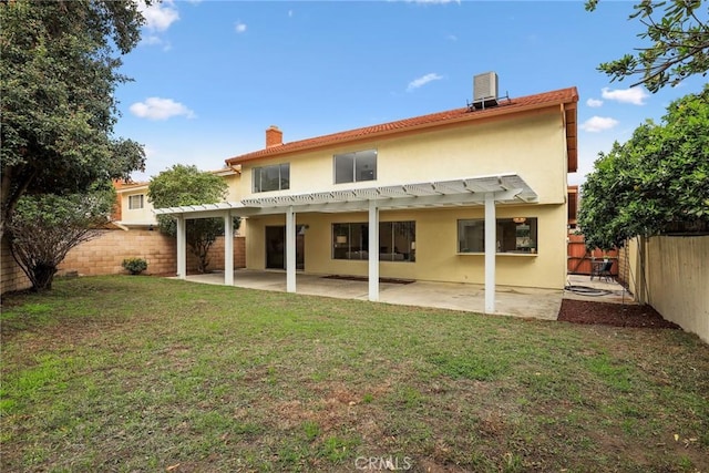 back of property with stucco siding, a pergola, a fenced backyard, a yard, and a patio area