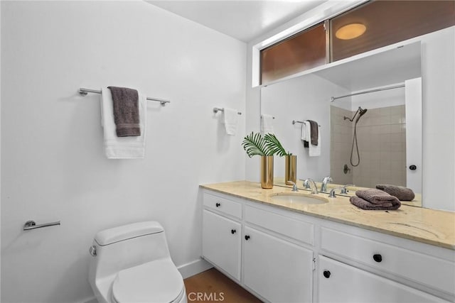 full bathroom featuring toilet, baseboards, walk in shower, and vanity