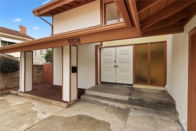 entrance to property featuring fence