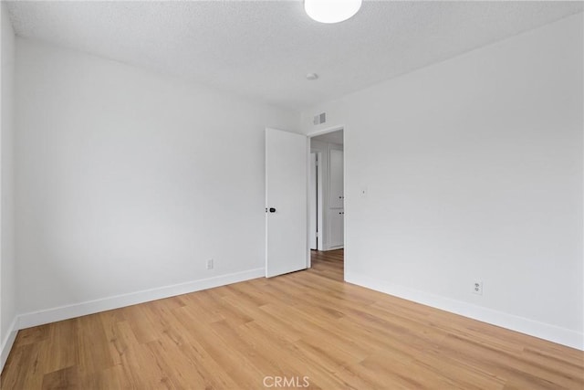 11328 Felson St, Cerritos, CA 90703 - spare room featuring light wood-type flooring, baseboards, and a textured ceiling