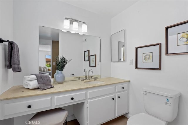 bathroom with toilet and vanity