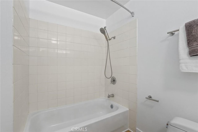 bathroom featuring toilet and bathtub / shower combination