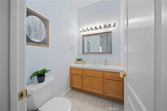 bathroom with tile patterned floors, toilet, and vanity