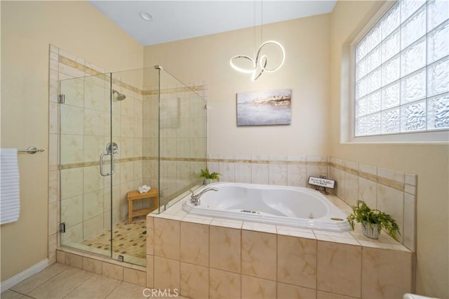 full bathroom featuring a shower stall, a tub with jets, baseboards, and tile patterned floors