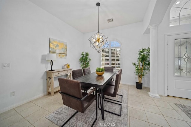 dining room featuring light tile patterned floors, baseboards, and ornate columns