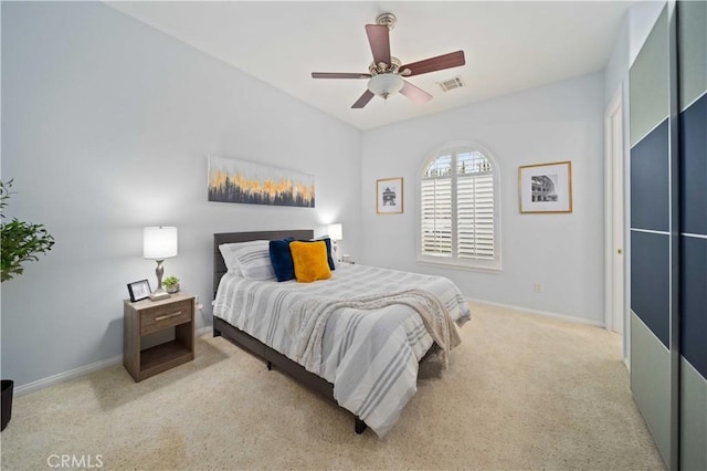 bedroom with light carpet, visible vents, a ceiling fan, and baseboards