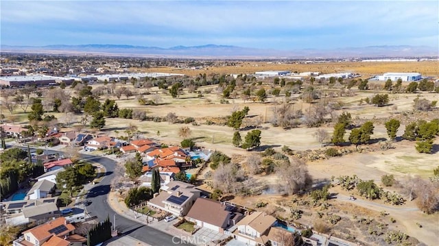 aerial view featuring a desert view, a mountain view, and a residential view