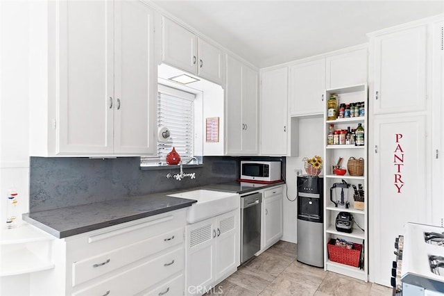 kitchen featuring open shelves, gas range gas stove, dishwasher, white cabinets, and a sink