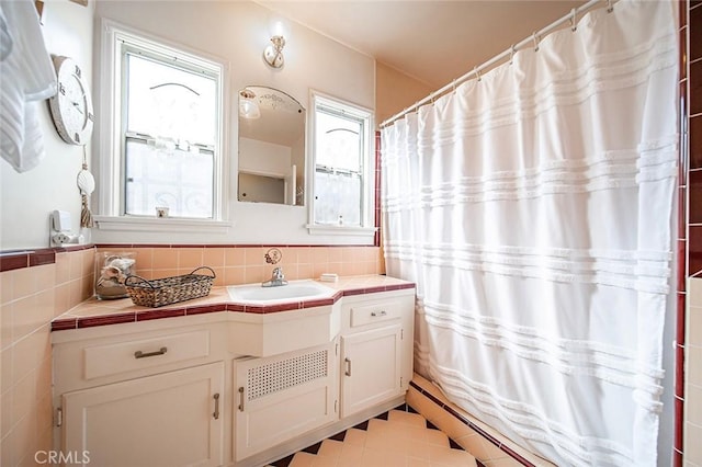 bathroom featuring tile walls and vanity