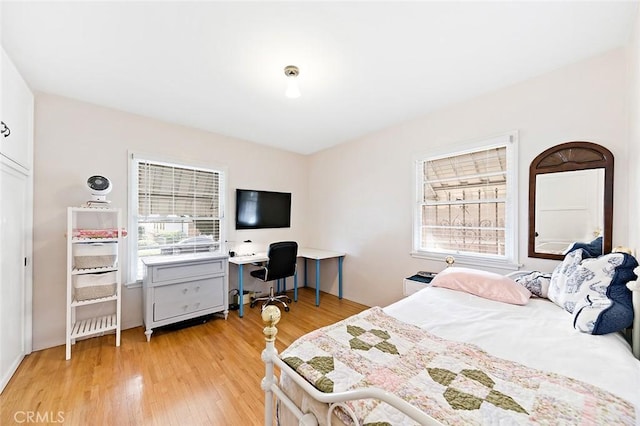 bedroom featuring light wood-style flooring