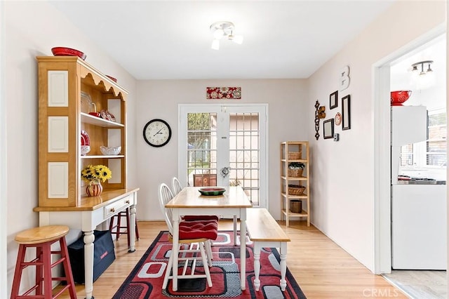 dining area featuring french doors and light wood finished floors