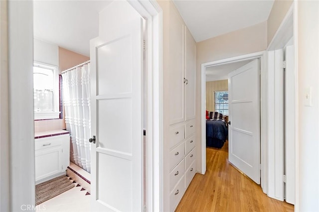 corridor with light wood-style floors