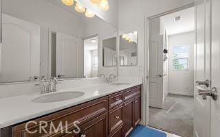 full bathroom featuring a sink and double vanity