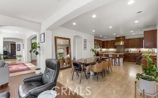 dining room featuring recessed lighting and arched walkways