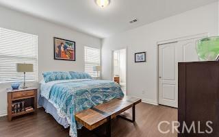 bedroom with dark wood-style floors and baseboards