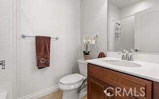 bathroom featuring vanity, toilet, and walk in shower