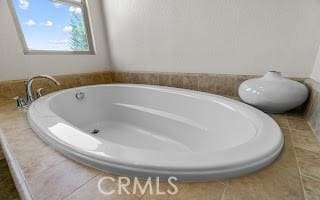 full bathroom with tile patterned floors and a bathing tub