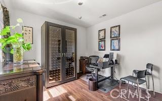 office with french doors and wood finished floors