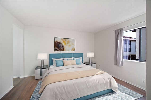 bedroom with wood finished floors and baseboards