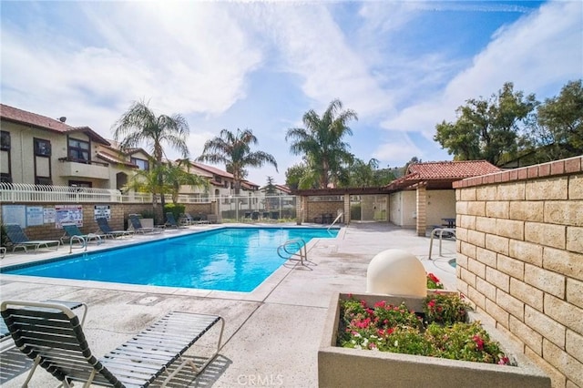 pool featuring a patio and fence