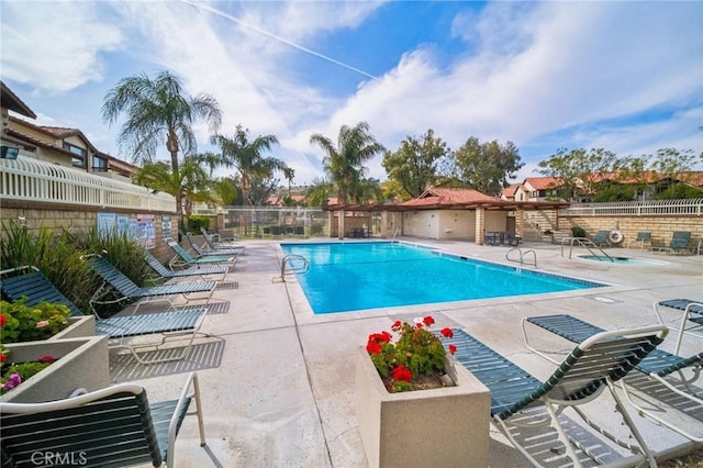 community pool featuring a patio area and fence