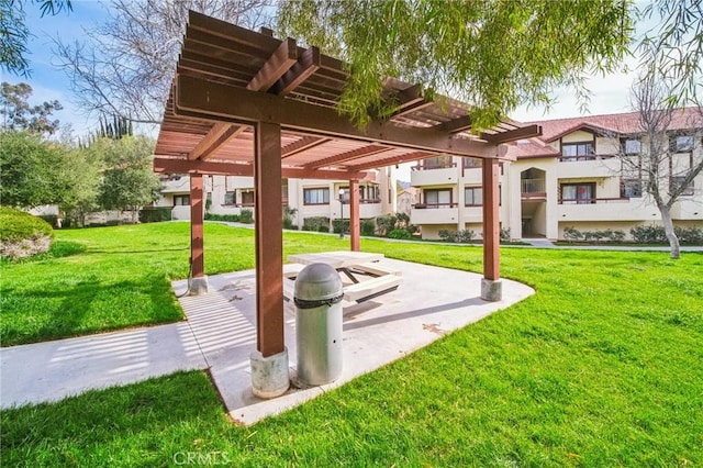 view of home's community with a lawn and a pergola