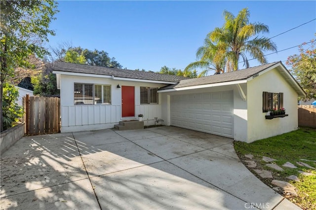 single story home with stucco siding, an attached garage, driveway, and fence