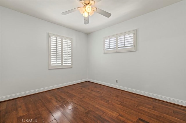 spare room with a ceiling fan, baseboards, and hardwood / wood-style floors