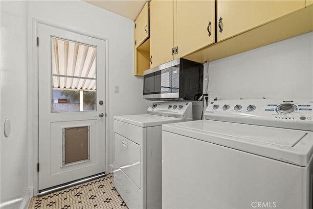 washroom featuring cabinet space and washing machine and clothes dryer