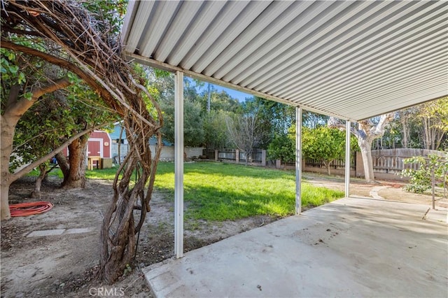 view of patio / terrace featuring an outbuilding, a storage shed, and a fenced backyard