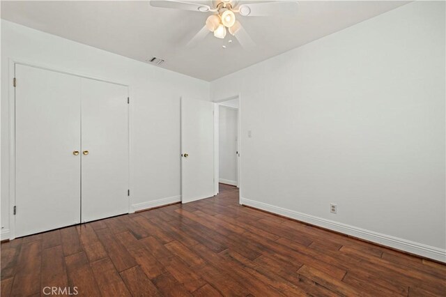 unfurnished bedroom featuring visible vents, baseboards, a ceiling fan, and hardwood / wood-style flooring