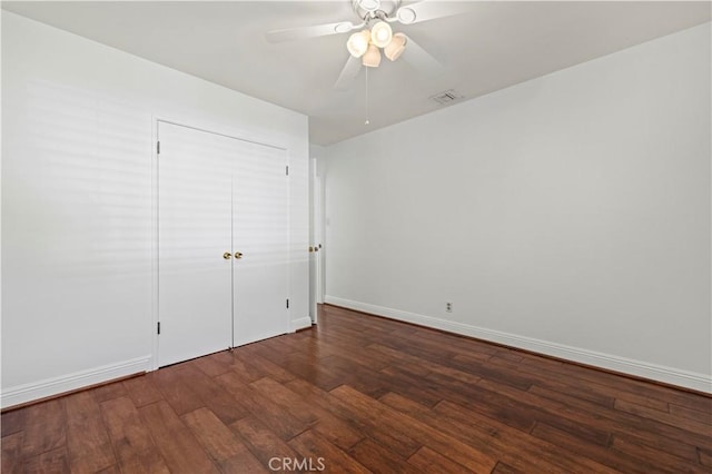 unfurnished bedroom with visible vents, a ceiling fan, baseboards, and wood finished floors