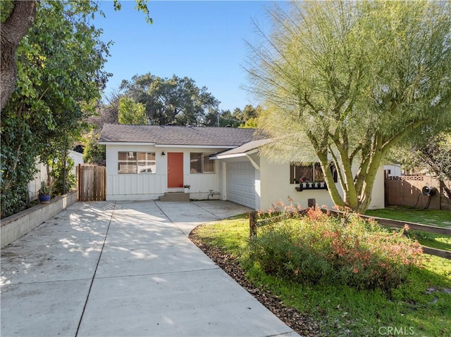 single story home with stucco siding, driveway, a garage, and fence