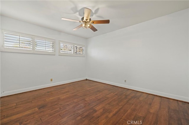 empty room with baseboards, wood finished floors, and a ceiling fan