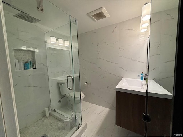 full bathroom with vanity, stone wall, marble finish floor, and a marble finish shower