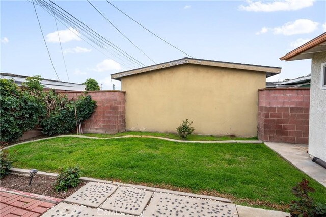 view of yard with an outdoor structure and fence