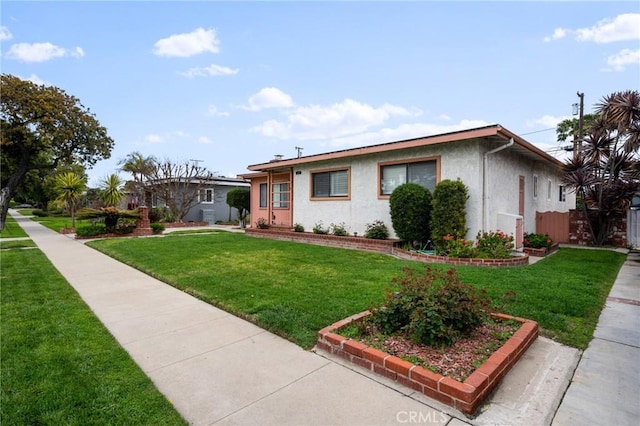 single story home featuring stucco siding and a front yard