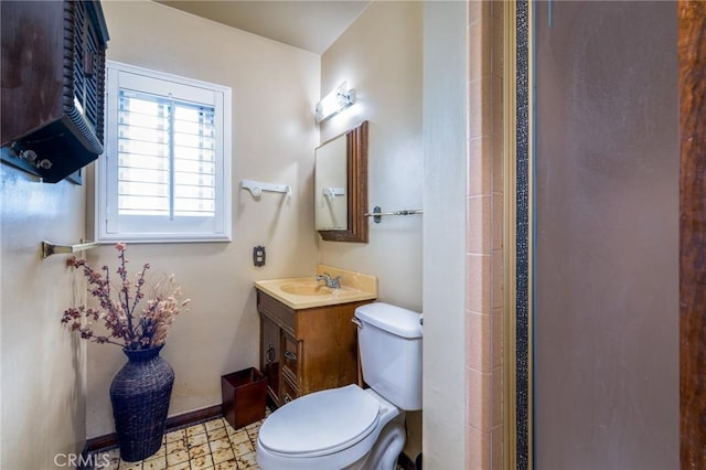 full bathroom with baseboards, toilet, tile patterned floors, vanity, and a shower