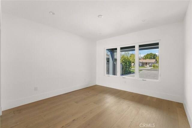 empty room featuring baseboards and wood finished floors