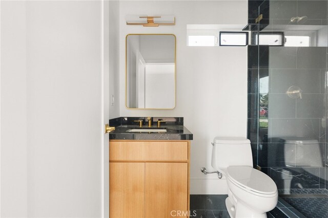 full bathroom with a shower stall, toilet, and vanity