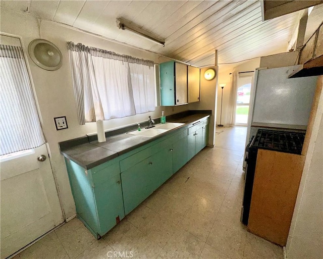 kitchen featuring green cabinetry, light floors, tile countertops, wooden ceiling, and a sink