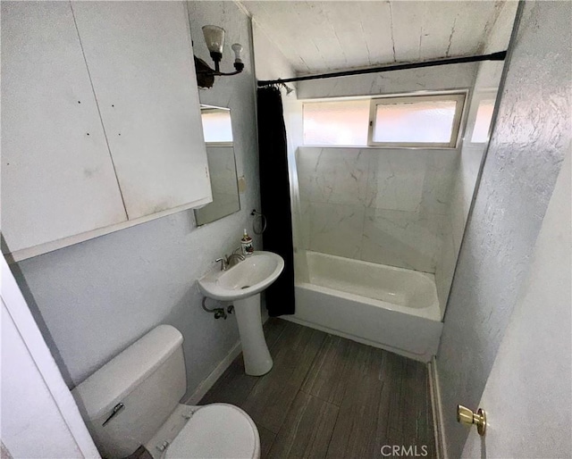 bathroom featuring toilet, bathtub / shower combination, and wood finished floors