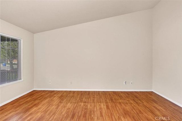 empty room with light wood-style flooring and baseboards