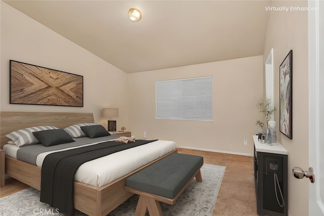 bedroom with baseboards, lofted ceiling, and light carpet